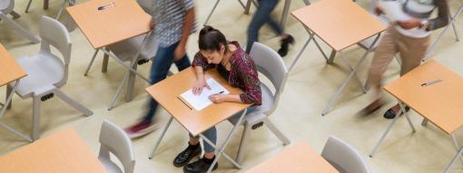 Girl Student Siting at Desk Writing